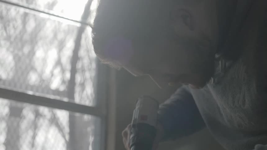 A man uses a drill
