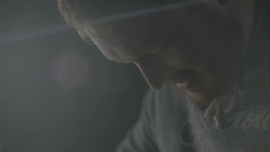A man with a beard stares down concentrating