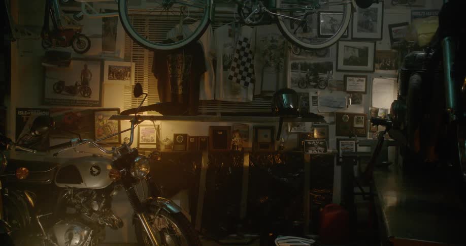 Man Working On Motorcycle In Garage