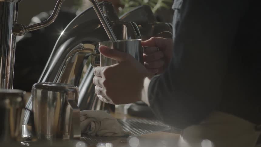 A metal mug being filled from a device