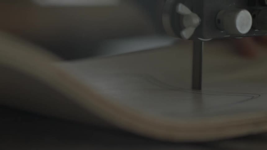 A board being cut on a band-saw