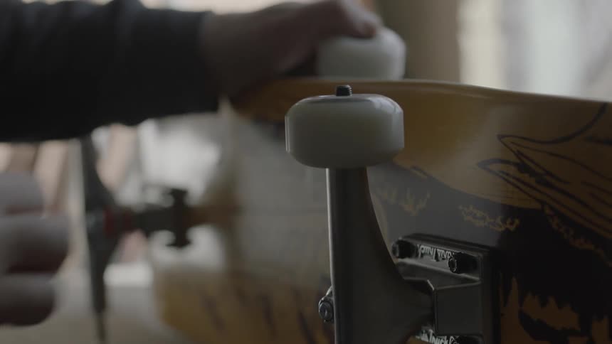 A man is fixing a skateboard