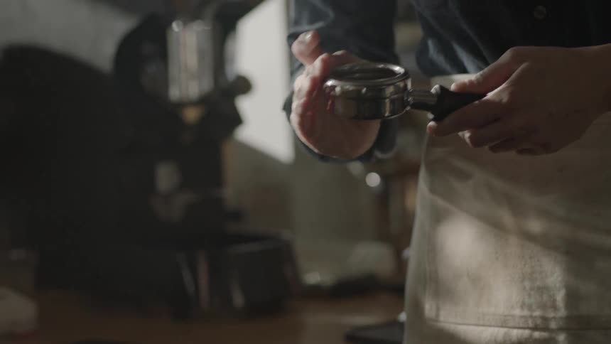 A man is preparing a coffee