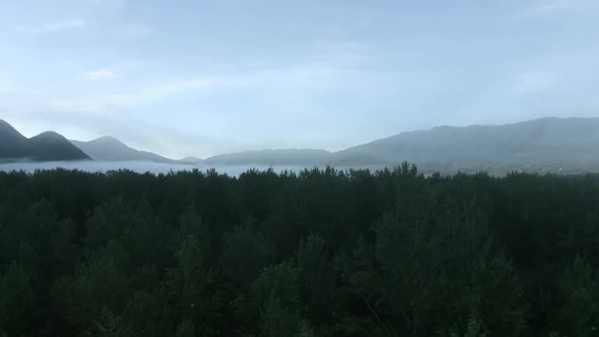 A mountain range over a forest