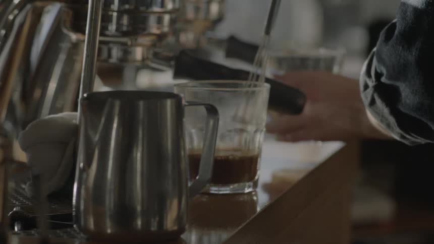 A man is brewing coffee