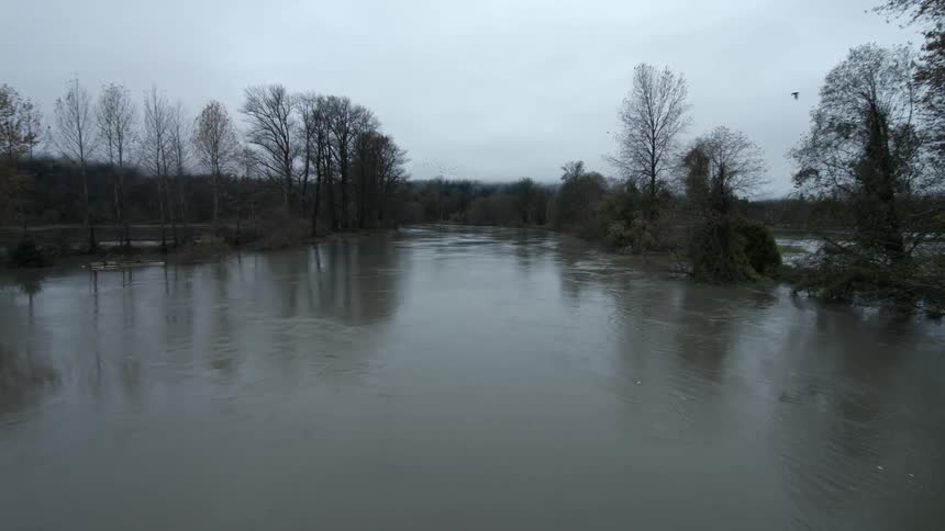 A lake is shown between trees