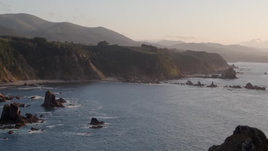 Large mountains overlooking a calm sea