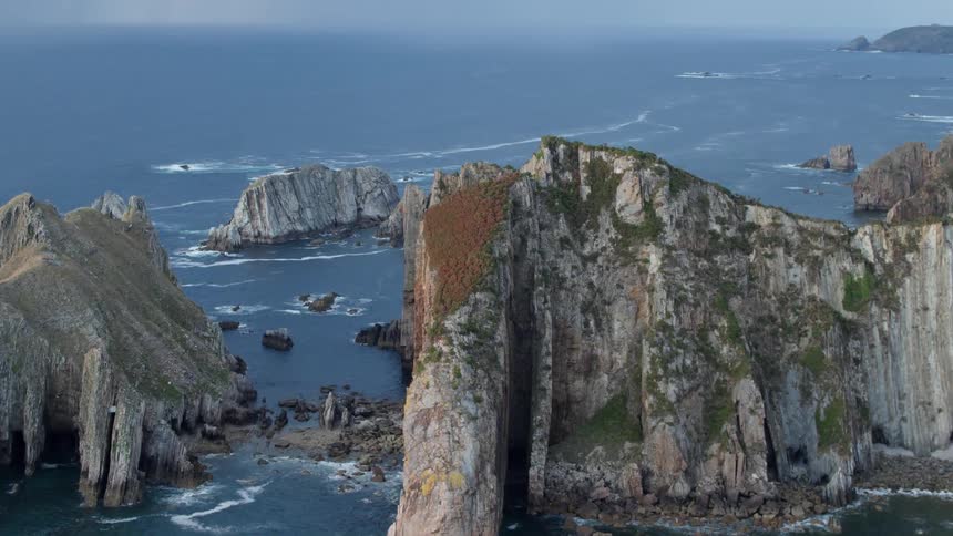 Some rocky cliffs that are along the ocean