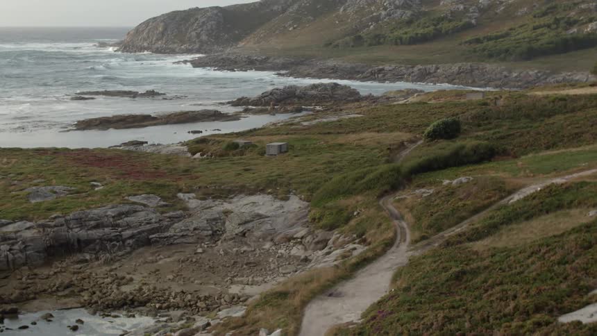 A rocky and grassy hill next to the sea