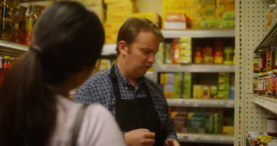 A grocery worker helps a customer