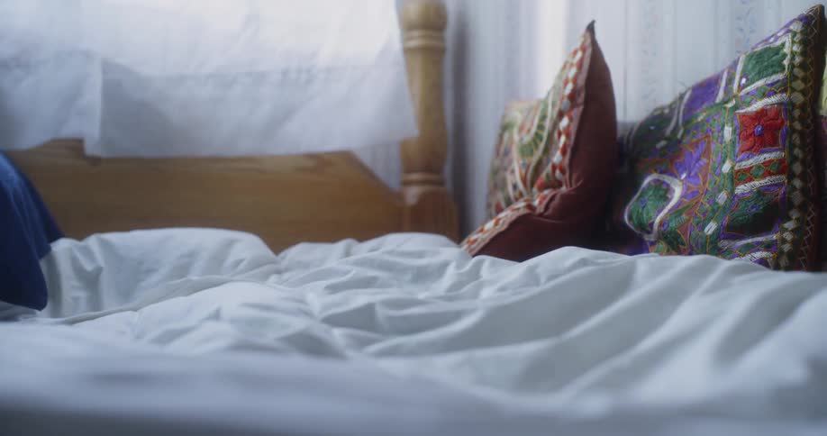Woman getting up from her bed
