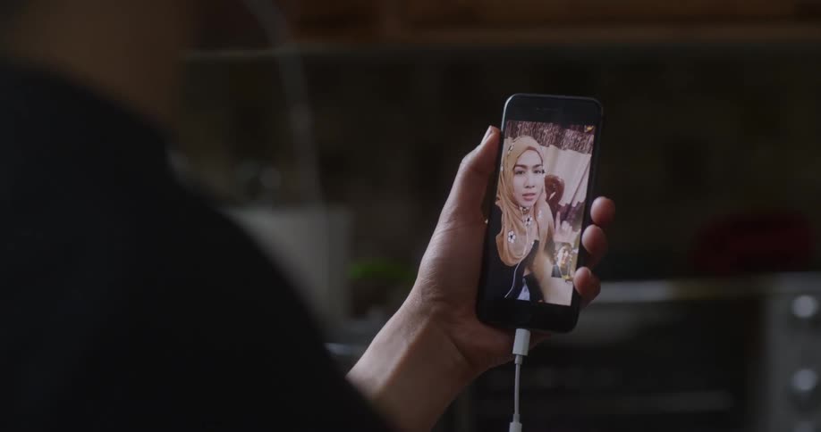 A person looking at a video feed on their phone