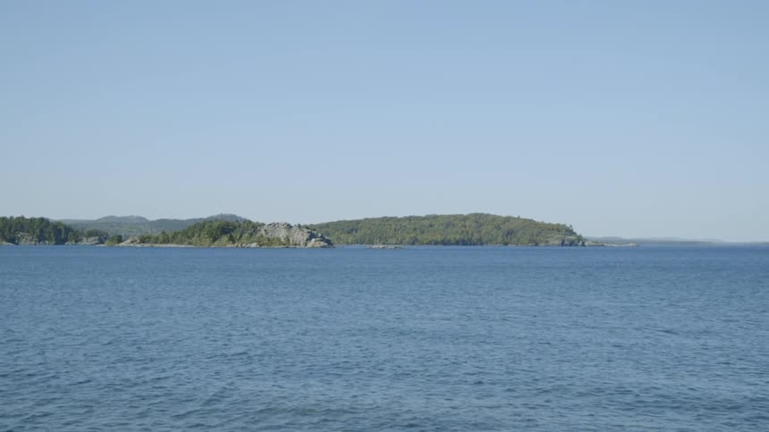 Calm sea next to rocky mountains