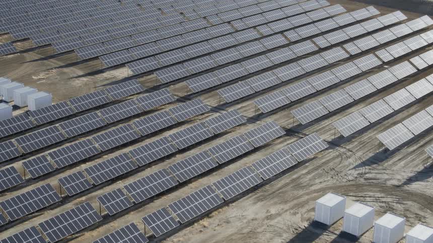 Pan over a solar panel field