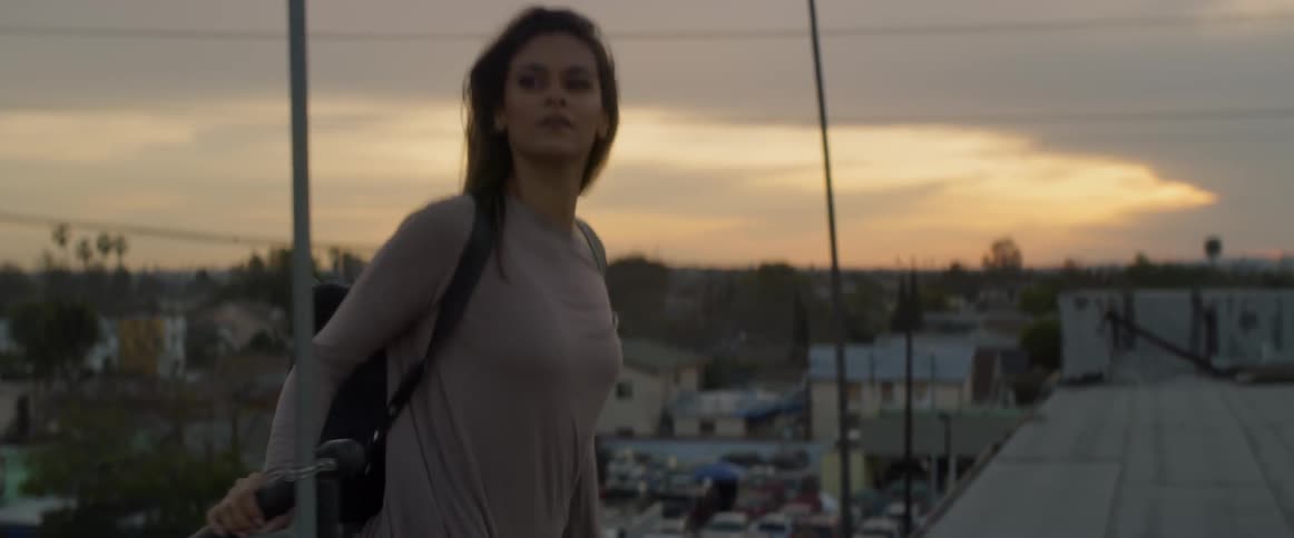 A woman walks up to the building rooftop