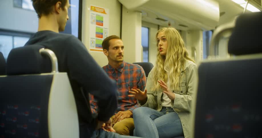 Woman talking with two men on a train