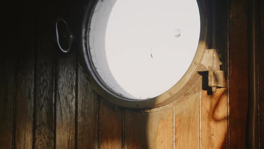 A circular window surrounded by wood planks