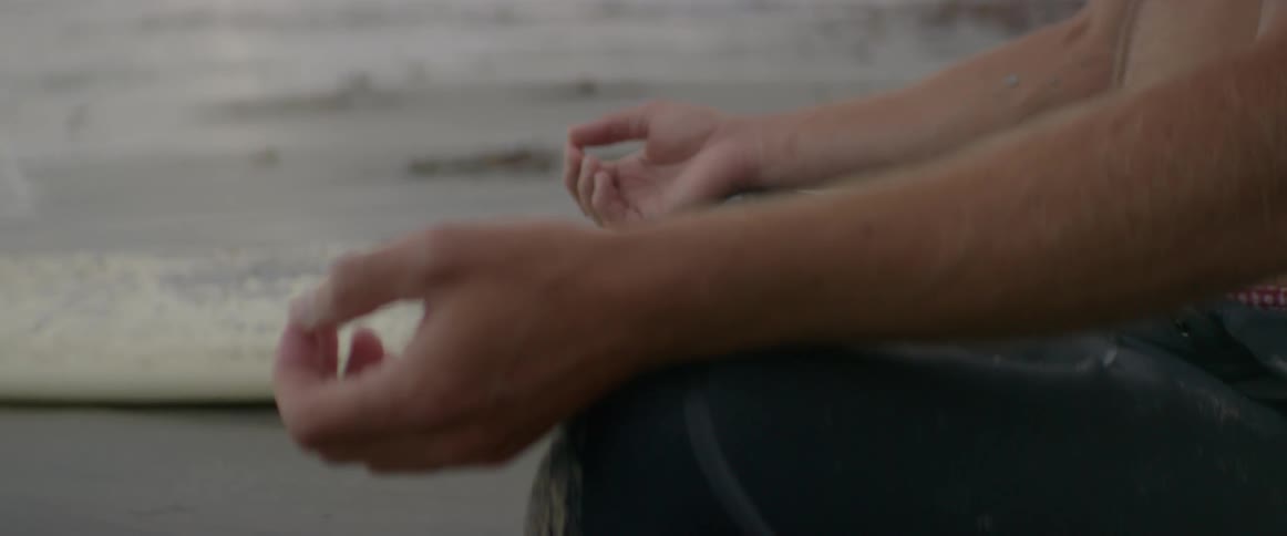 A person meditates while sitting