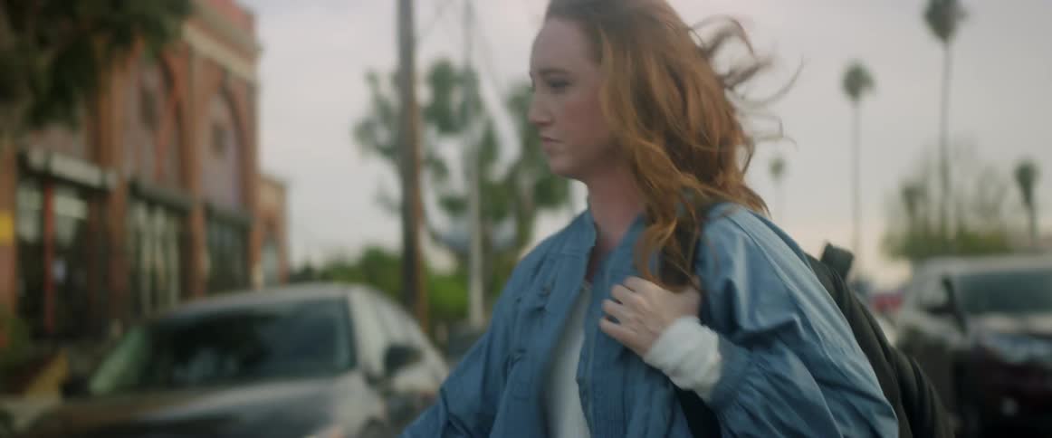 Woman walking across a road