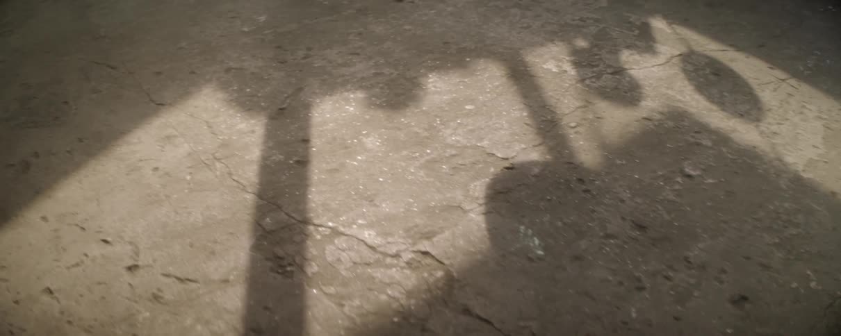 A shadow on the ground of people moving