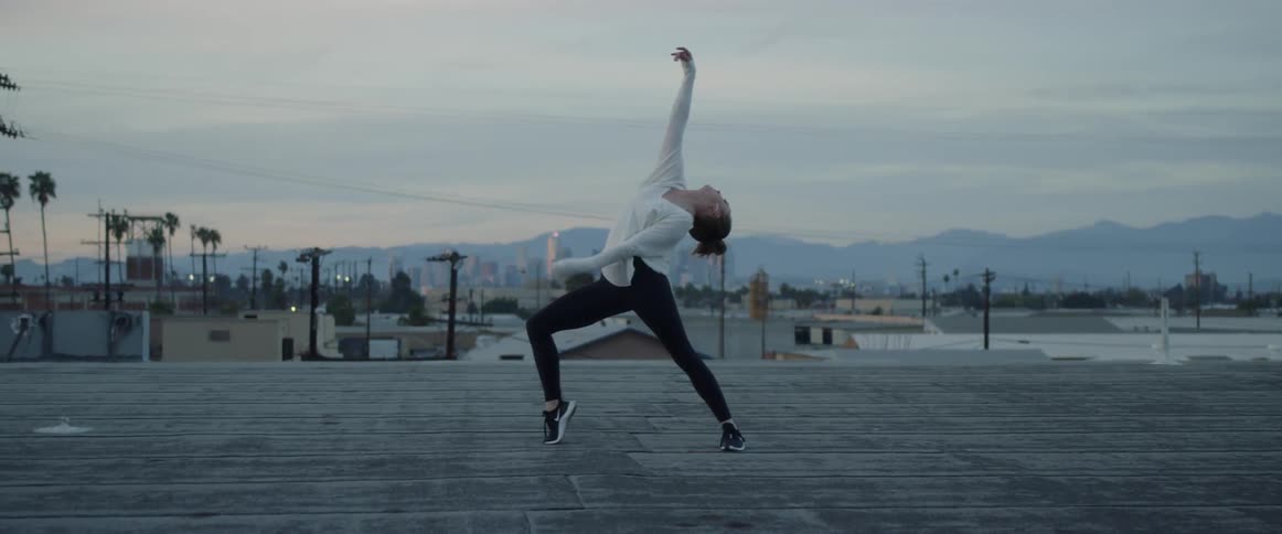 Dancers On Rooftop Overlooking City