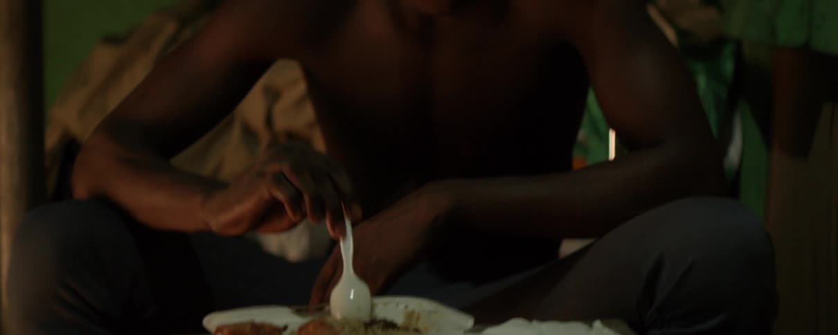 Man picking at food with a spoon while eating