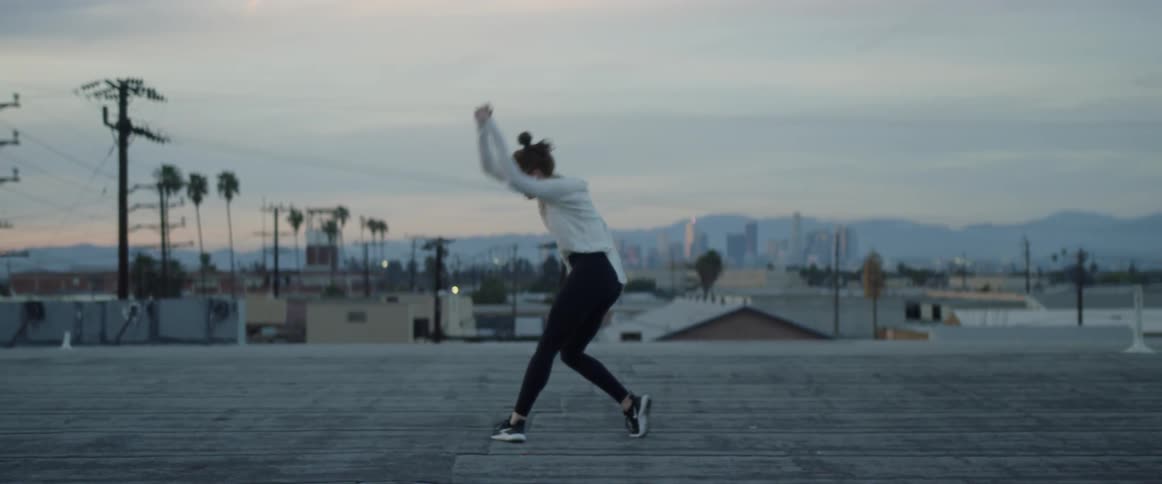 Dancers On Rooftop Overlooking City