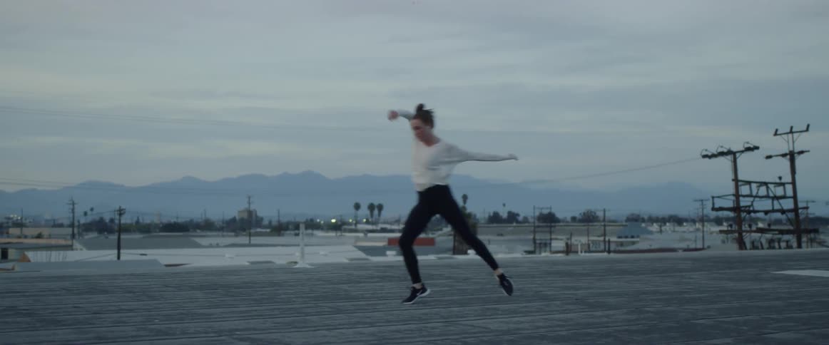 Dancers On Rooftop Overlooking City