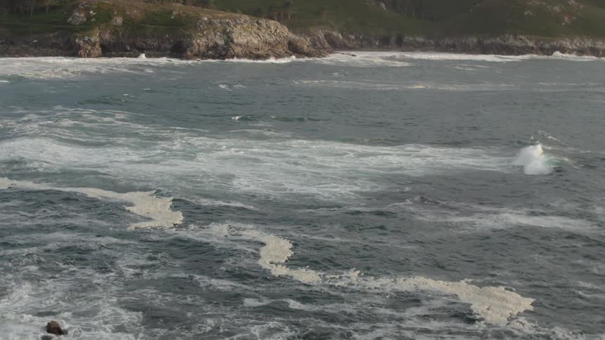 The waves are moving, and crashing into the rocks