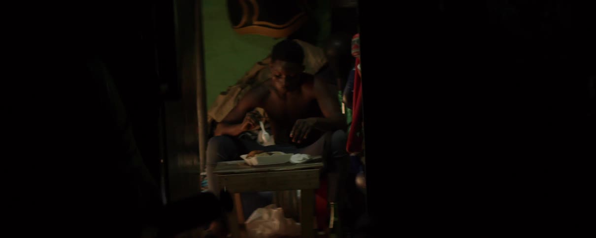 A man eats with a plastic spoon