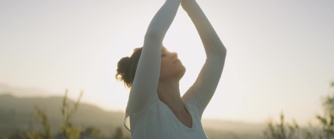 Woman stretching outdoors on a sunny day