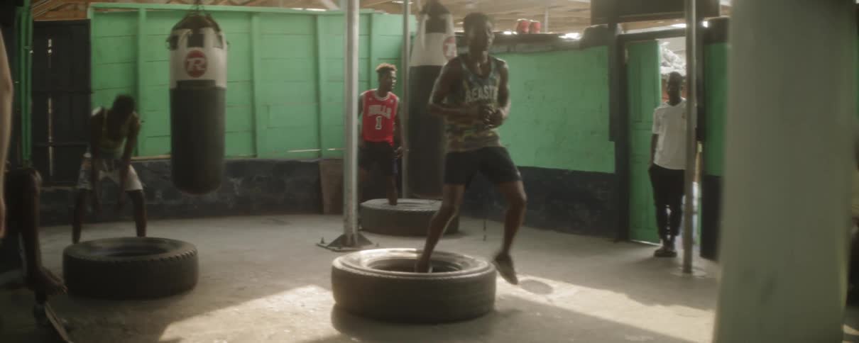 A male fighter training in a large tire