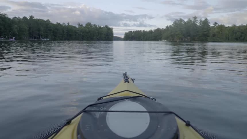 A kayak moves through a tranquil river