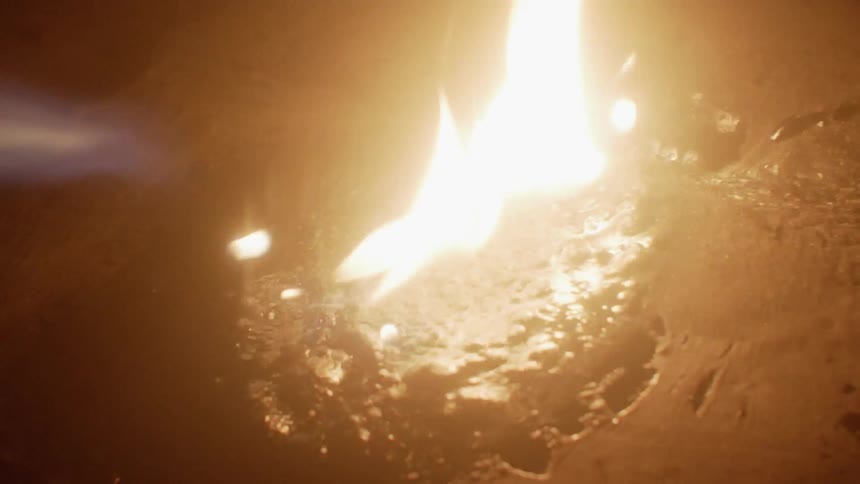 Someone torches what looks like tar