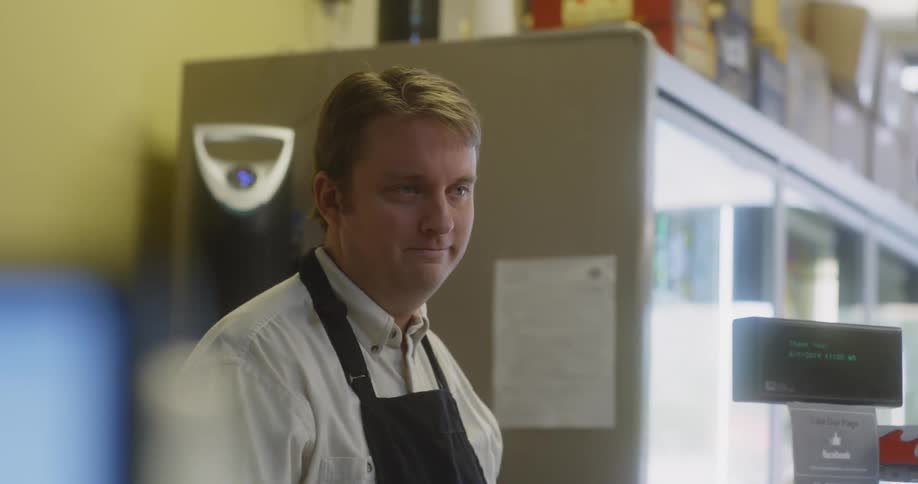 A man in an apron sadly explains something