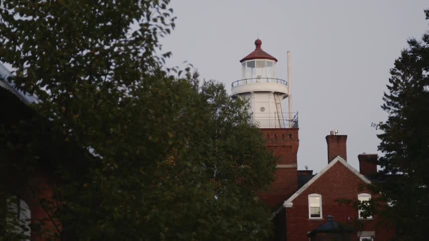A large bulb blinks inside a lighthouse