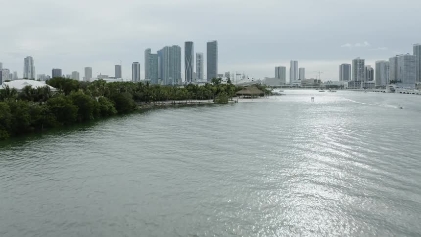 A river leads to a large city full of skyscrapers