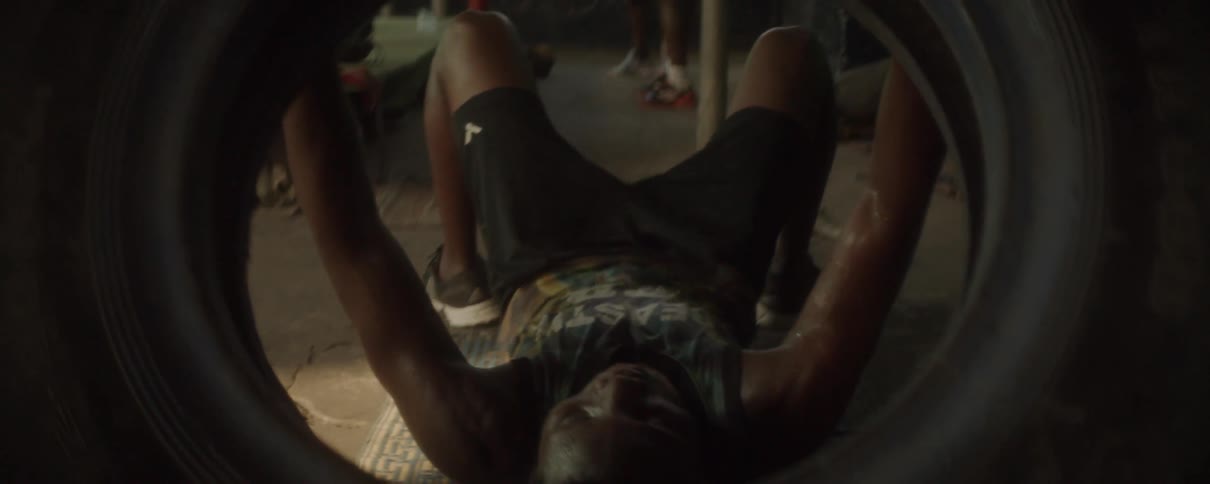 A man exercises with a large tire