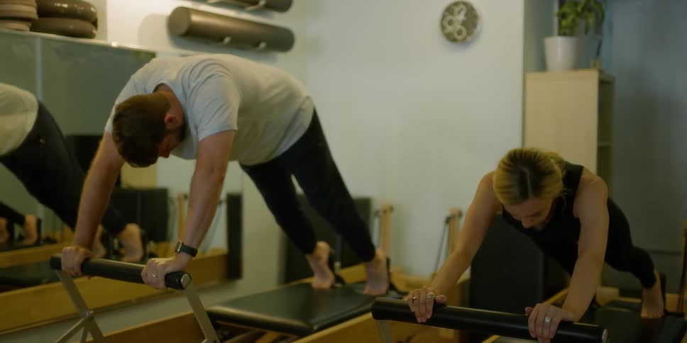 Woman Instructing Pilates Class