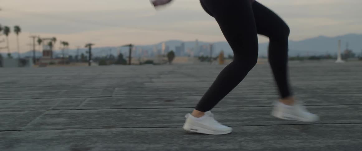 A woman dances on a rooftop