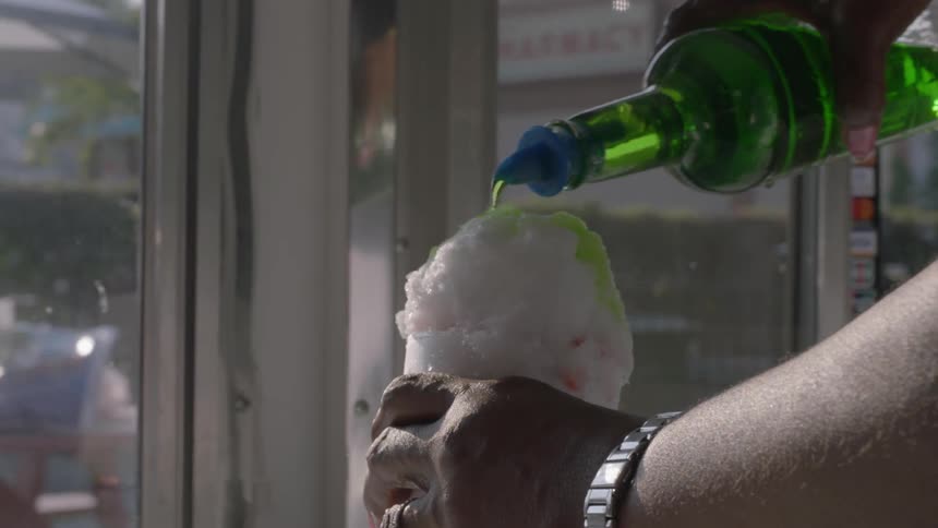 A person making a snow cone in a store