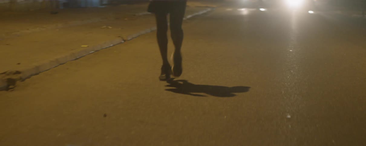 Man running down a street at night