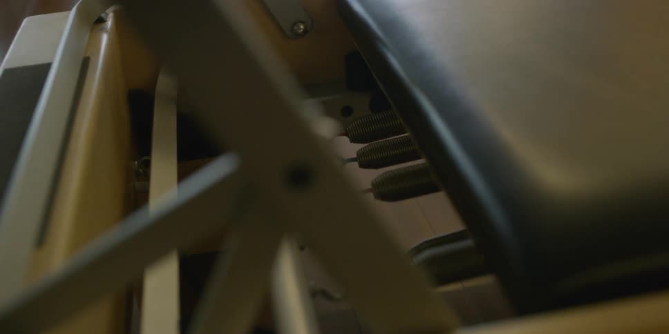 Someone readjusts tension bars and puts them on different hooks