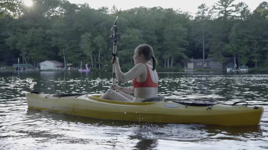 Girl Kayaks in Lake