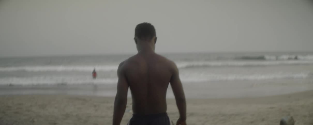 A man walks on the sandy beach
