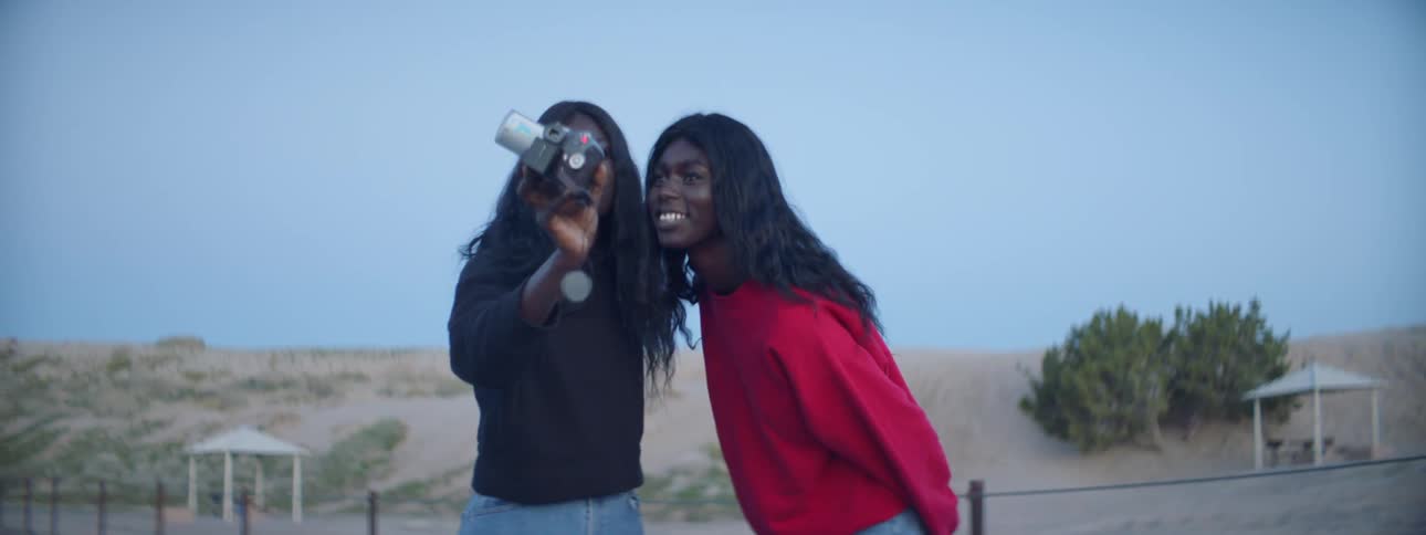 Sisters Filming Each Other With Camcorder