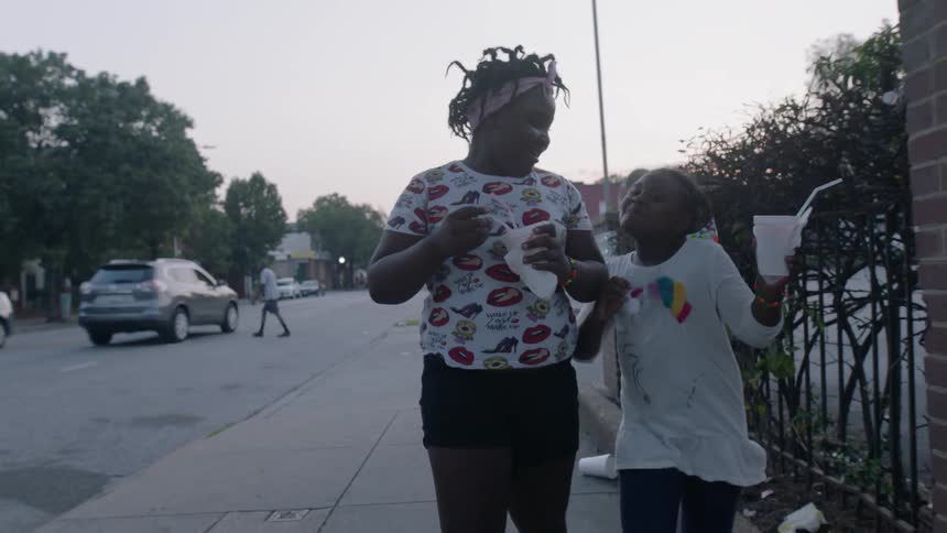 Two girls walking down the street dancing