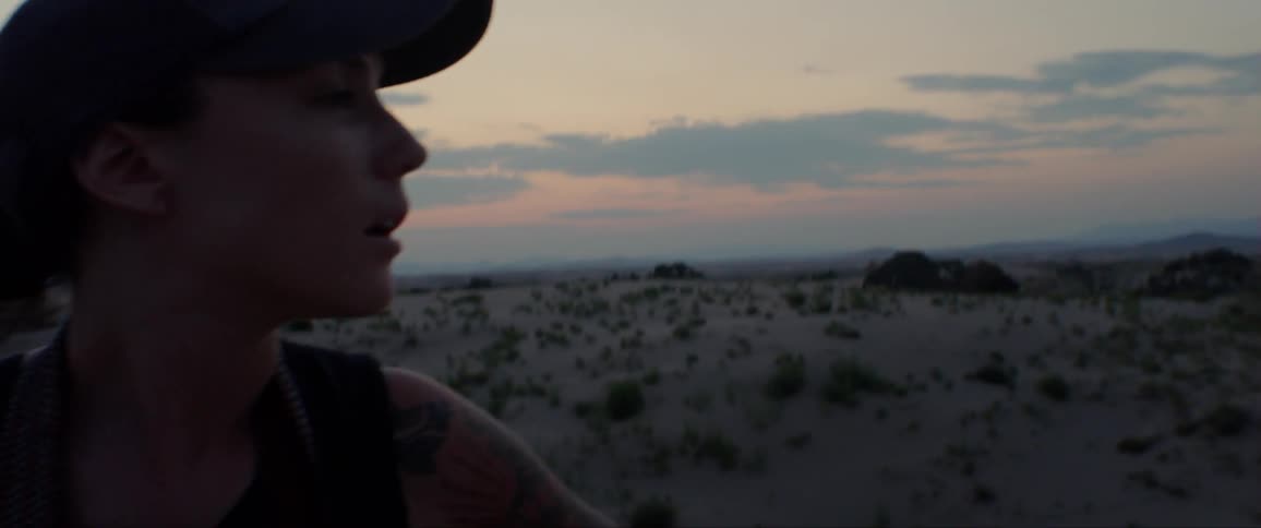 Woman Exploring Sand Dunes At Dusk