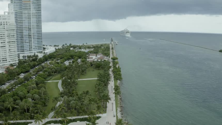 Buildings on a large island and ship floating out to sea