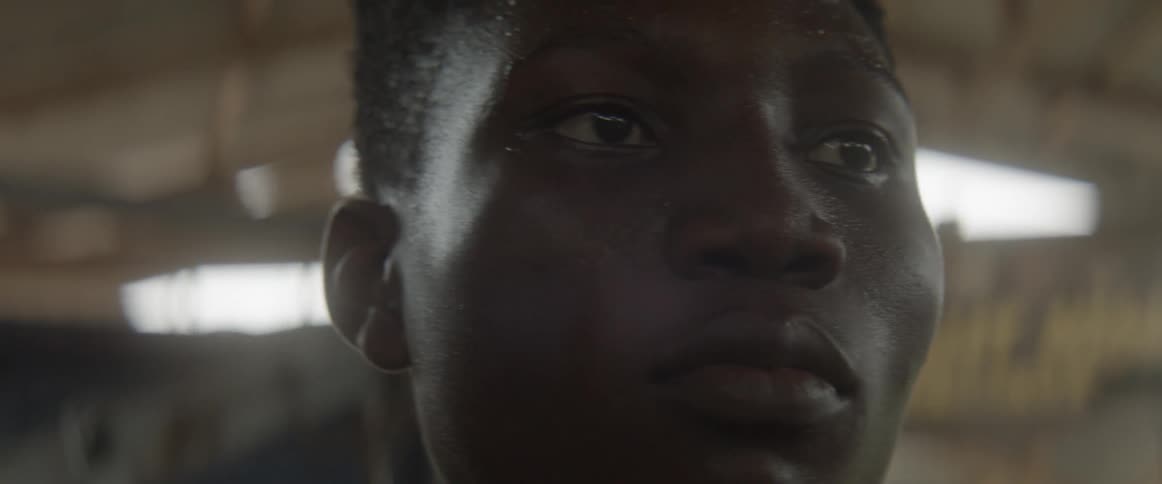 A serious young black man concentrates on the day around him